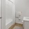 a bathroom with a white tile shower with tub