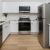 a kitchen with white counter tops
