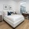 a bedroom with large windows