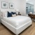 a bedroom with large windows