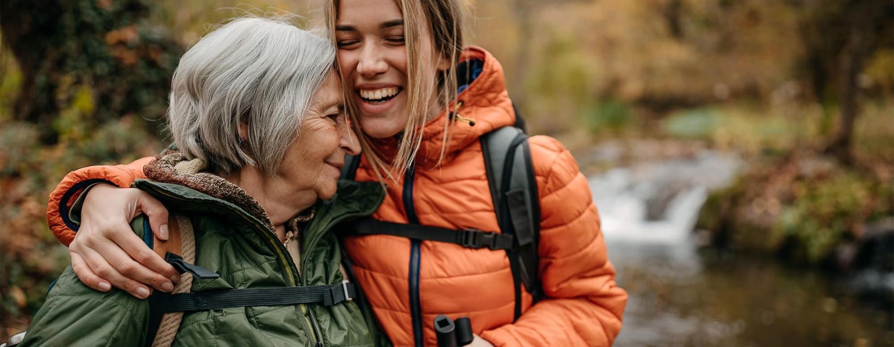 a couple of women smiling while hiking